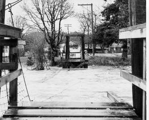 Image of the 1964 flood overtaking the swinging bridge.